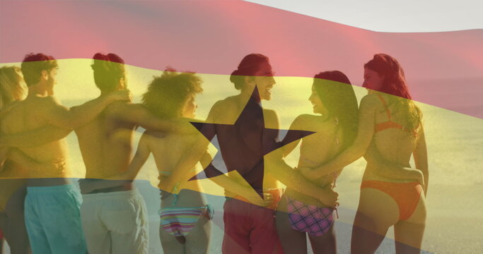Naklejki Image of waving ghana flag over diverse friends standing and forming chain at beach