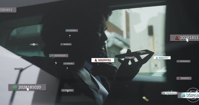 Image of social media notifications over african american woman in face mask using phone in car