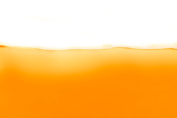 Fototapeta na wymiar The surface of the orange water ripples looks like beer.