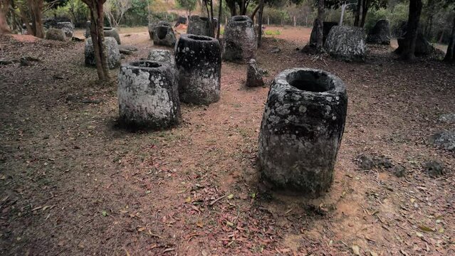 Plain of Jars, Drone fly through jungle closeup to megalithic structures. Phonsavanh, Laos.