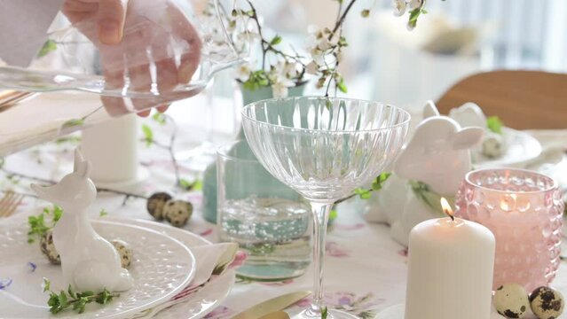 Spring Easter decor. Easter table setting. Flowers and dishes and candles for a festive dinner. High quality footage