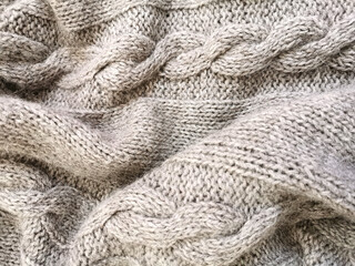 Knitted canvas handmade from gray natural fluffy cozy warm sheep yarn  close-up winter texture background