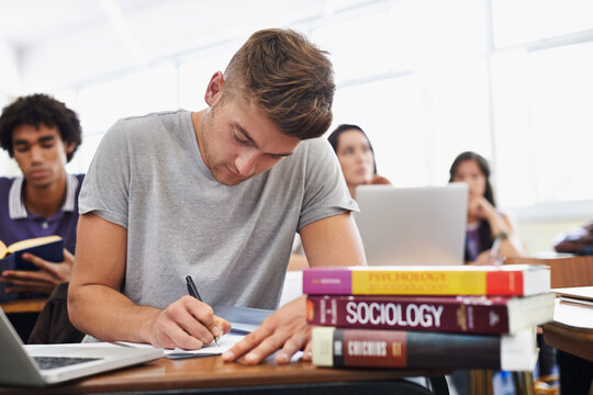 Student, man and writing with textbooks, education and university with exams and research for test. Person, college and guy with ideas or laptop with inspiration or studying with learning or deadline