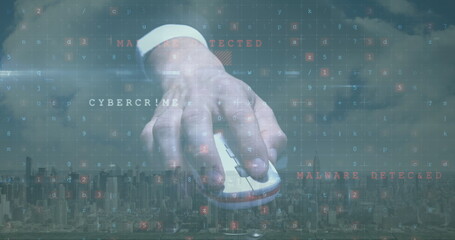 Image of cyber attack warning with hand holding computer mouse over cityscape