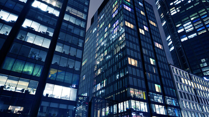 Office building at night, building facade with glass and lights. View with illuminated modern skyscraper. - 757819110