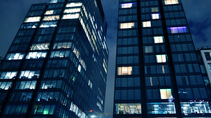 Office building at night, building facade with glass and lights. View with illuminated modern skyscraper. - 757819333
