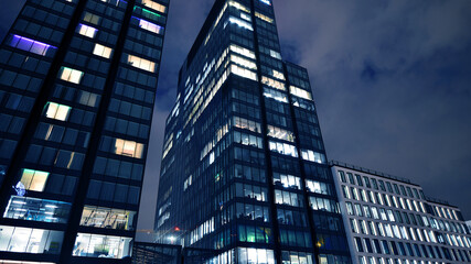 Office building at night, building facade with glass and lights. View with illuminated modern skyscraper. - 757819337