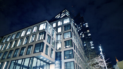 Office building at night, building facade with glass and lights. View with illuminated modern skyscraper. - 757819502