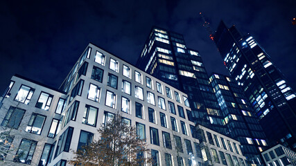Office building at night, building facade with glass and lights. View with illuminated modern skyscraper. - 757819536