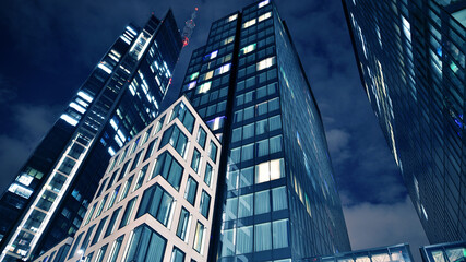 Office building at night, building facade with glass and lights. View with illuminated modern skyscraper. - 757819734