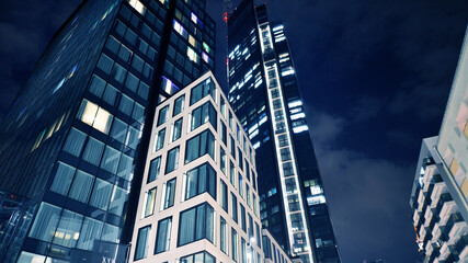 Office building at night, building facade with glass and lights. View with illuminated modern skyscraper. - 757819771