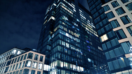 Office building at night, building facade with glass and lights. View with illuminated modern skyscraper. - 757819963