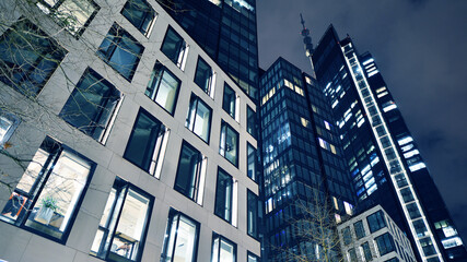 Office building at night, building facade with glass and lights. View with illuminated modern skyscraper. - 757820310