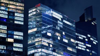 Office building at night, building facade with glass and lights. View with illuminated modern skyscraper. - 757820905