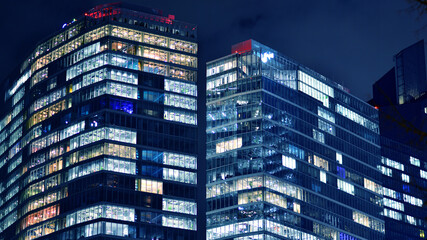 Office building at night, building facade with glass and lights. View with illuminated modern skyscraper. - 757820916