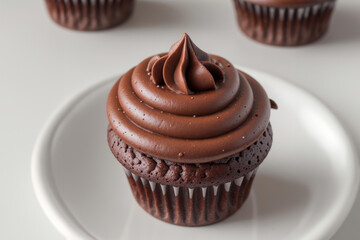 Chocolate Cupcake With Swirled Frosting on a White Plate