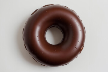 Chocolate Doughnut Sprinkled with Chocolate Chips on a White Table