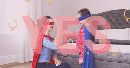 Image of yes text over superhero mother and daughter