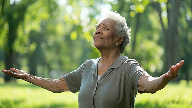 Senior woman outdoors feeling grateful with arms open wide.
