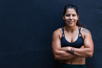 Fototapeta na wymiar Woman fitness trainer portrait on a black background