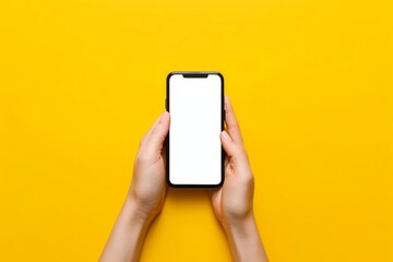 A person is holding a cell phone with two hands with a yellow background - Powered by Adobe