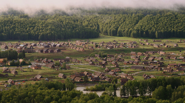 Hemu village on Kanas Nature Reserve, enveloped in fog.