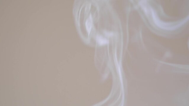 The smoke rises upwards from the red censer