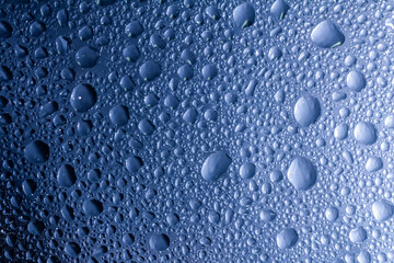 Drops of water on a color background. Selective focus. Gray