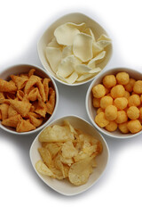 Top view of white ceramic bowls with different kind of chips isolated on white background