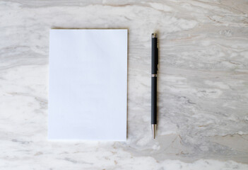 Blank paper sheet and pen, mockup on marble table, simplicity and minimal, nobody, flat lay, top view - 757851556