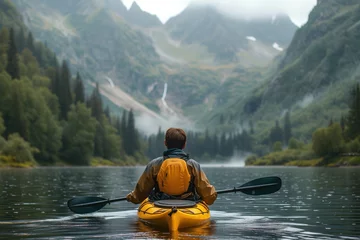 Fotobehang Man Paddling Yellow Kayak Down River © Jelena