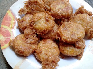 Perkedel kentang or mashed potato fritters. First, fry the potatoes first, once cooked, mash the potatoes and mix with some spices, then shape into rounds and fry with egg coating. Indonesian dish.