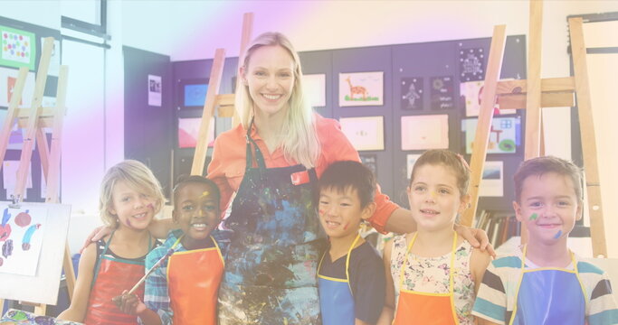 Image of smiling caucasian female teacher painting with diverse schoolchildren