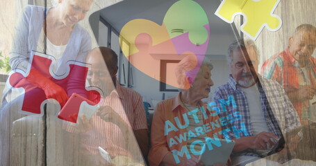 Image of colourful puzzle pieces and autism text over senior friends using electronic devices