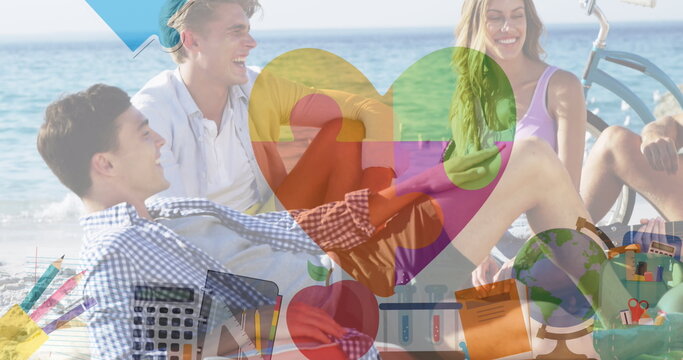 Image of colourful puzzle pieces heart over happy friends at summer beach party - Powered by Adobe