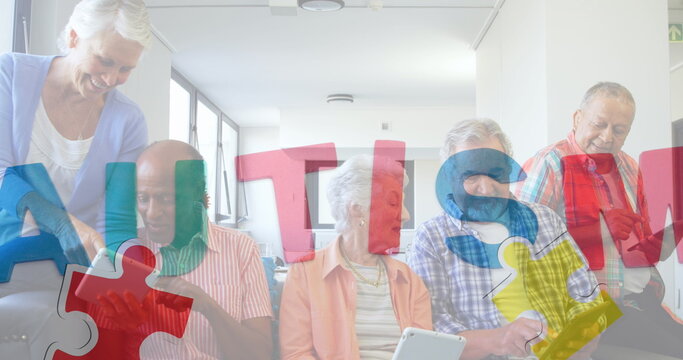 Image of colourful puzzle pieces and autism text over senior friends using electronic devices - Powered by Adobe