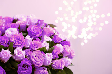 Bouquet of violet roses against blurred background, closeup. Funeral attributes