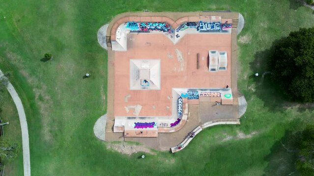 Bird's-eye landscape drone aerial people scootering The Entrance skatepark concrete ramps half pip fun box pyramid Long Jetty Central Coast tourism