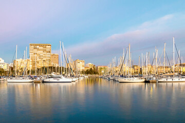 Beautiful port of Alicante at sunrise, Spain at Mediterranean sea. Luxury yachts, ships, ferries...