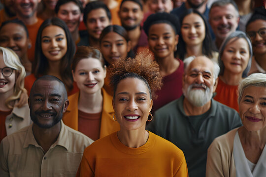A large diverse group of people, including men and women from various ethnic backgrounds, are depicted smiling and facing the camera in an overhead shot.
