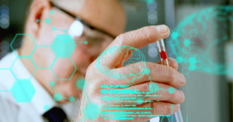 Image of data flowing over a mid section view of a male laboratory worker examining blood sample