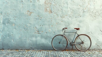 A solitary bicycle leaning against a plain wall, symbolizing freedom and simplicity in transportation,