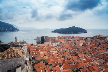 Amazing panoramic view of picturesque Dubrovnik old town, towers, narrow stone streets and buildings with red roofs on Adriatic sea coast, Croatia. - 757870579