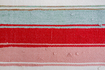 Striped multi-colored handmade fabric canvas background, textile texture close-up copy space
