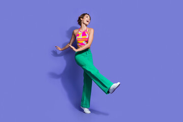 Fototapeta na wymiar Photo of glad lovely woman wear stylish clothes dance celebrate holiday look empty space isolated on purple color background