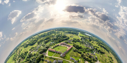 Aerial view from high altitude tiny planet in sky with clouds overlooking old town, urban development, buildings and crossroads. Transformation of spherical 360 panorama in abstract aerial view. - obrazy, fototapety, plakaty