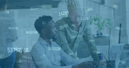 Image of numbers changing over diverse male coworkers in office