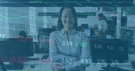 Image of financial graphs and data over happy asian woman in office