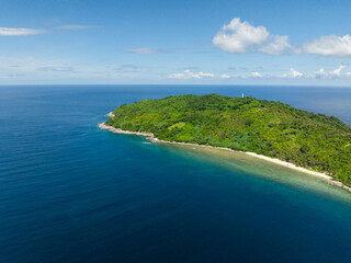 Fototapeta na wymiar Cagbuli Island with beach and blue sea. Blue sky and clouds. El Nido, Palawan. Philippines.