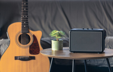 Close up, music speaker and acoustic guitar in the interior of the room.